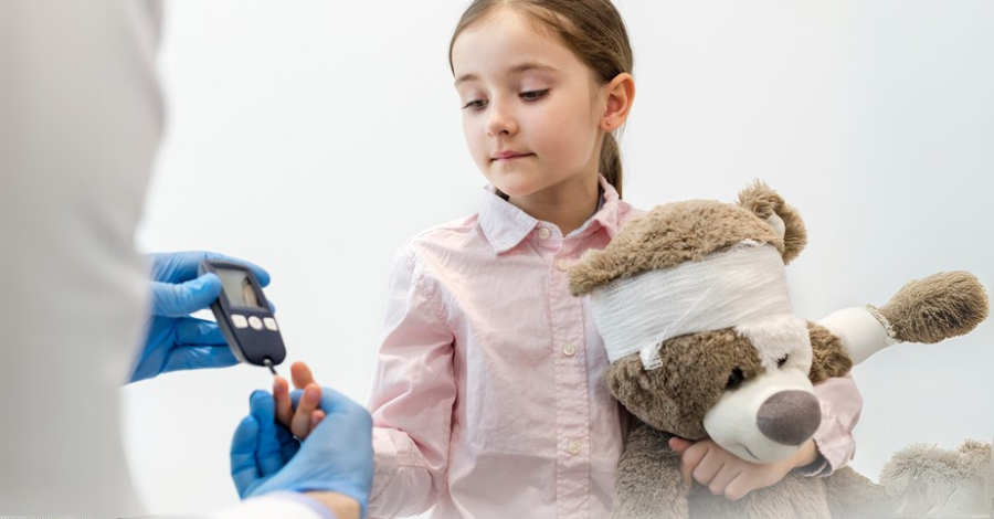 a girl holding a teddy bear blood sugar